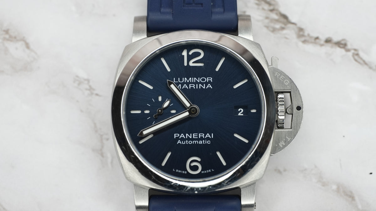 Close front view of Panerai Luminor Marina PAM01370 blue dial, small seconds, date window and polished steel bezel.