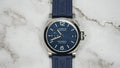 Panerai Luminor Marina PAM01370 with blue dial, stainless steel case and blue rubber strap, front view on marble.